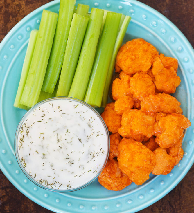 Vegan Buffalo Cauliflower Wings with ranch dip and celery