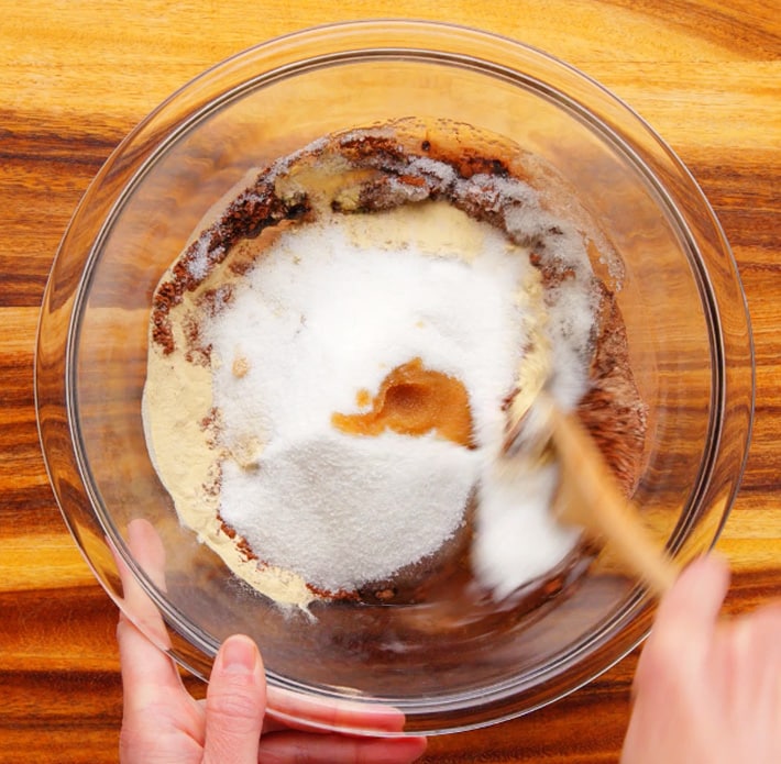 Stirring Brownie Ingredients In A Bowl with a spoon
