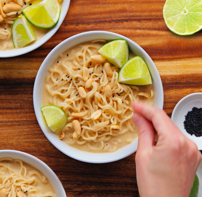 Vegan Ramen Bowls, with sesame seeds, peanuts, and sliced lime toppings