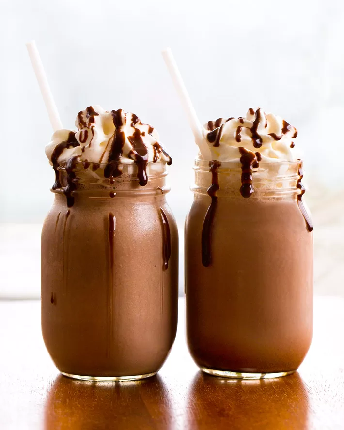 Chocolate Smoothies with whipped cream in mason jars