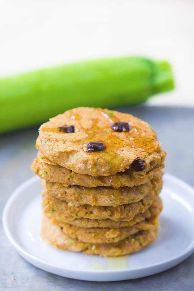 A giant stack of extra fluffy zucchini pancakes, stuffed with melty gooey chocolate chips and covered in hot maple syrup - These disappear so quickly whenever I make them: https://chocolatecoveredkatie.com/2015/08/10/zucchini-pancakes-healthy-vegan/