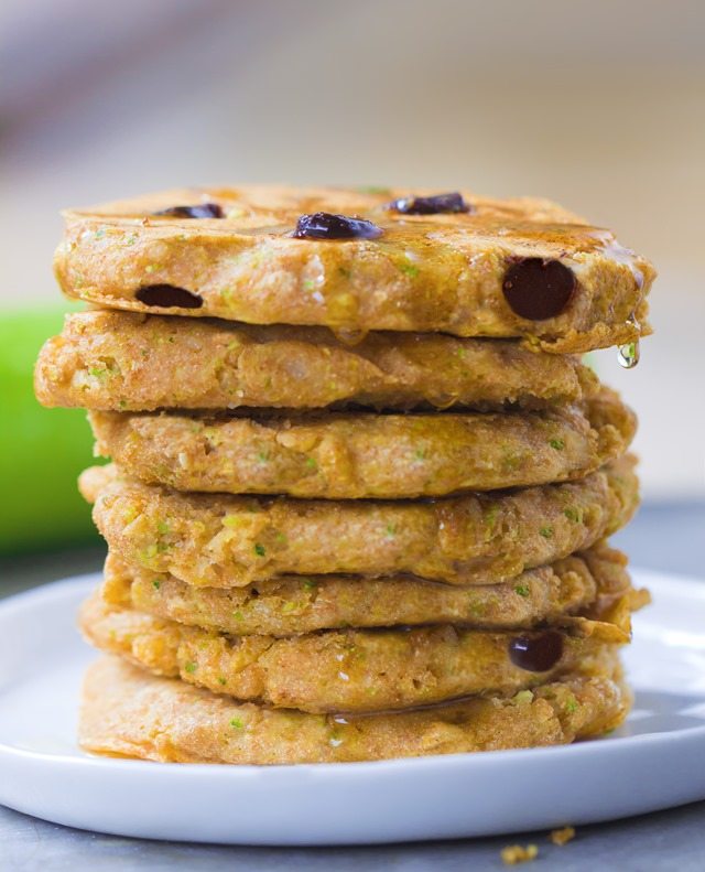 A giant stack of extra fluffy zucchini pancakes, stuffed with melty gooey chocolate chips - These disappear so quickly whenever I make them: https://chocolatecoveredkatie.com/2015/08/10/zucchini-pancakes-healthy-vegan/